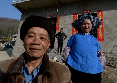 Rural residents pose in front of their new houses near the city of Anshun, Guizhou Province, in February 2014. (Mark Ralston/AFP/Getty Images)