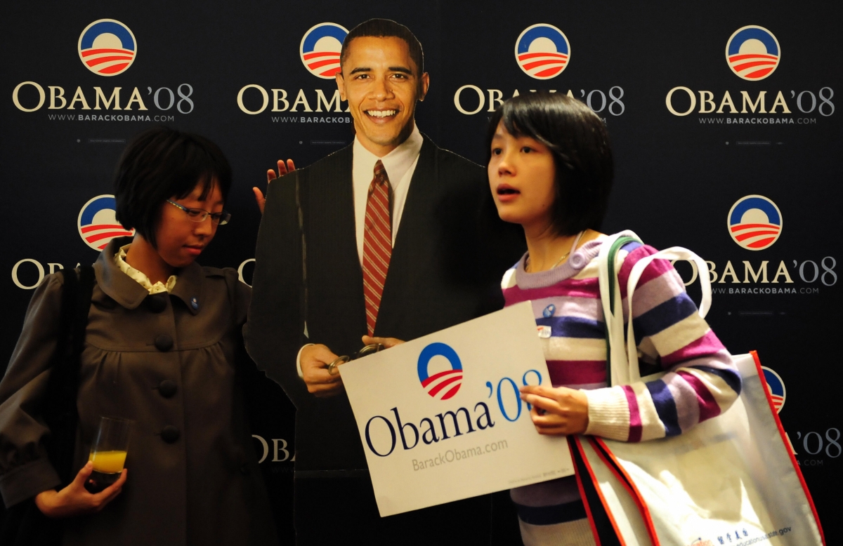 Young Chinese stand beside a lifesize cutout image of Barack Obama after he won the US presidential race at an election day event organized by the US embassy in Beijing on Nov. 5, 2008. (FREDERIC J. BROWN/AFP/Getty Images)