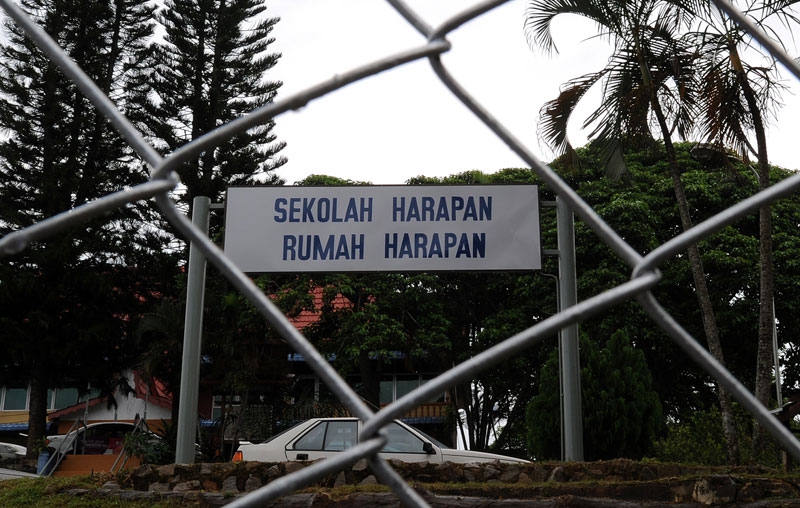 A freshly painted sign-board reads 'School of hope and house of hope' in front of a newly established school for pregnant teenagers in Jasin town, some 33 kilometers away from Malaysia's port city Malacca, on September 17, 2010. (Saeed Khan/AFP/Getty Images)