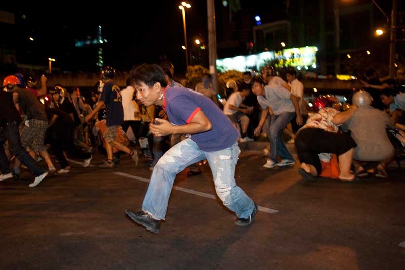 Anti-government Thai demonstrators flee during a clash with soldiers near central Bangkok's Lumphini Park on May 13, 2010. (Paula Bronstein/Getty Images)