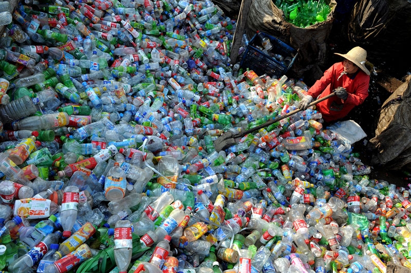 A Chinese worker piles up the plastic bottles collected at a recycling center in Hefei, east China's Anhui province. (STR/AFP/Getty Images)