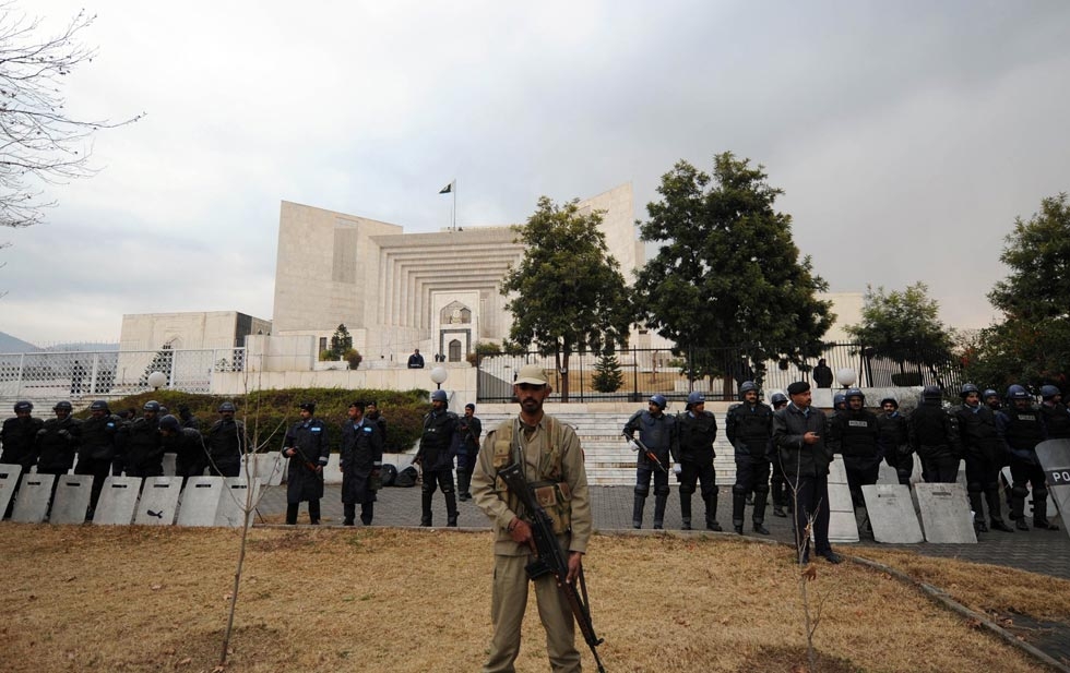 Pakistani security personnel stand guard outside the Supreme Court building during a hearing in Islamabad on Jan. 19, 2012. (Aamir Qureshi/AFP/Getty Images) 