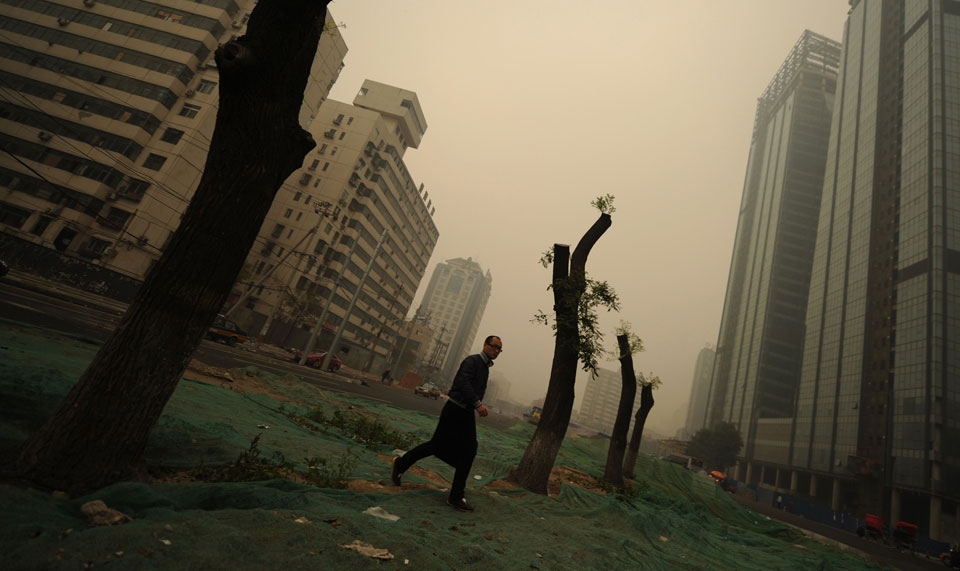 A man walks through heavy pollution on a street in Beijing. (Peter Parks/AFP/Getty Images)