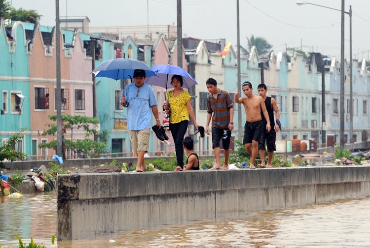 Pedestrians in Manila negotiate a flooded street. (Ted Aljibe/AFP/Getty)
