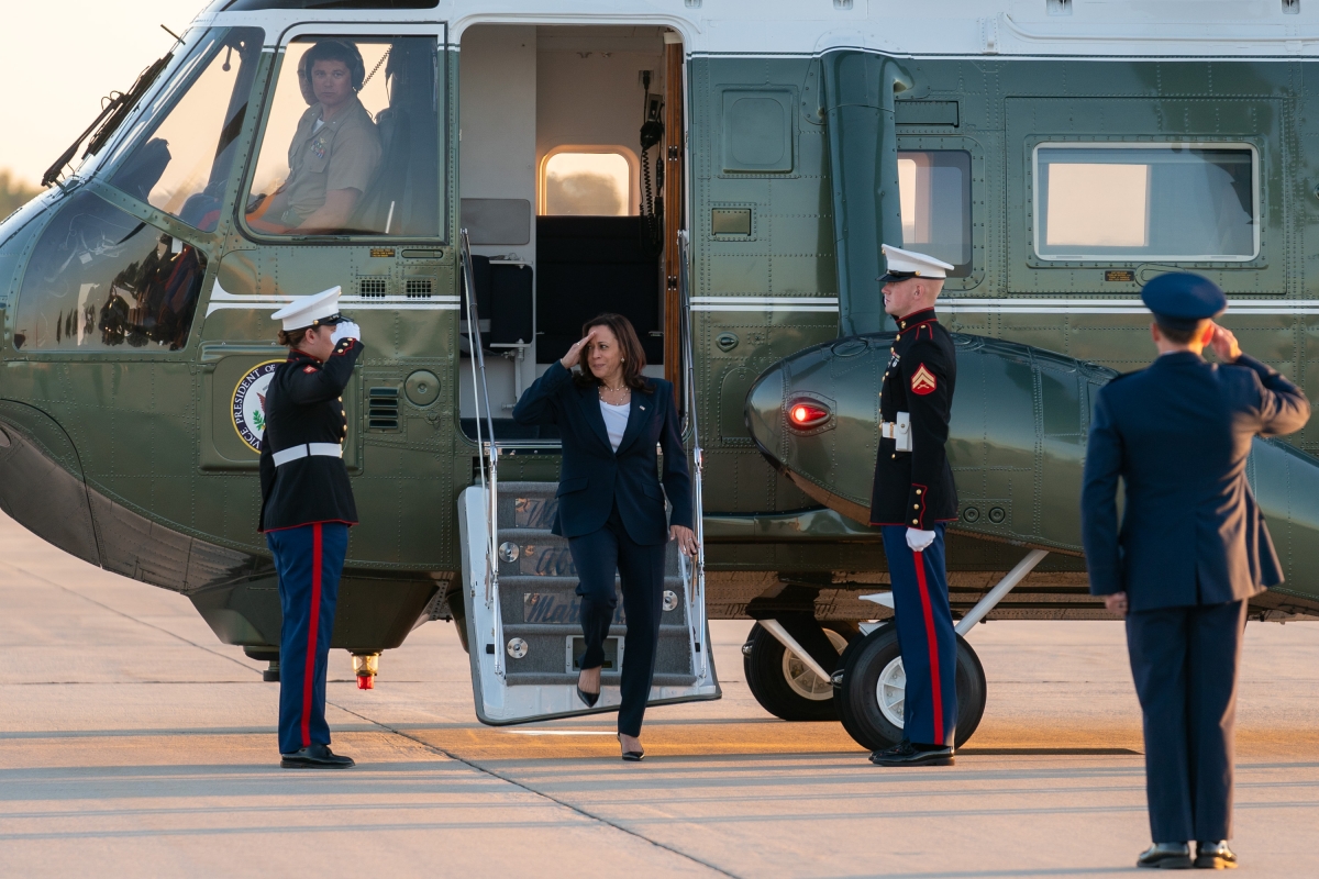 Vice President Kamala Harris salutes U.S. Marines as she disembarks Marine Two at Joint Base Andrews, Maryland
