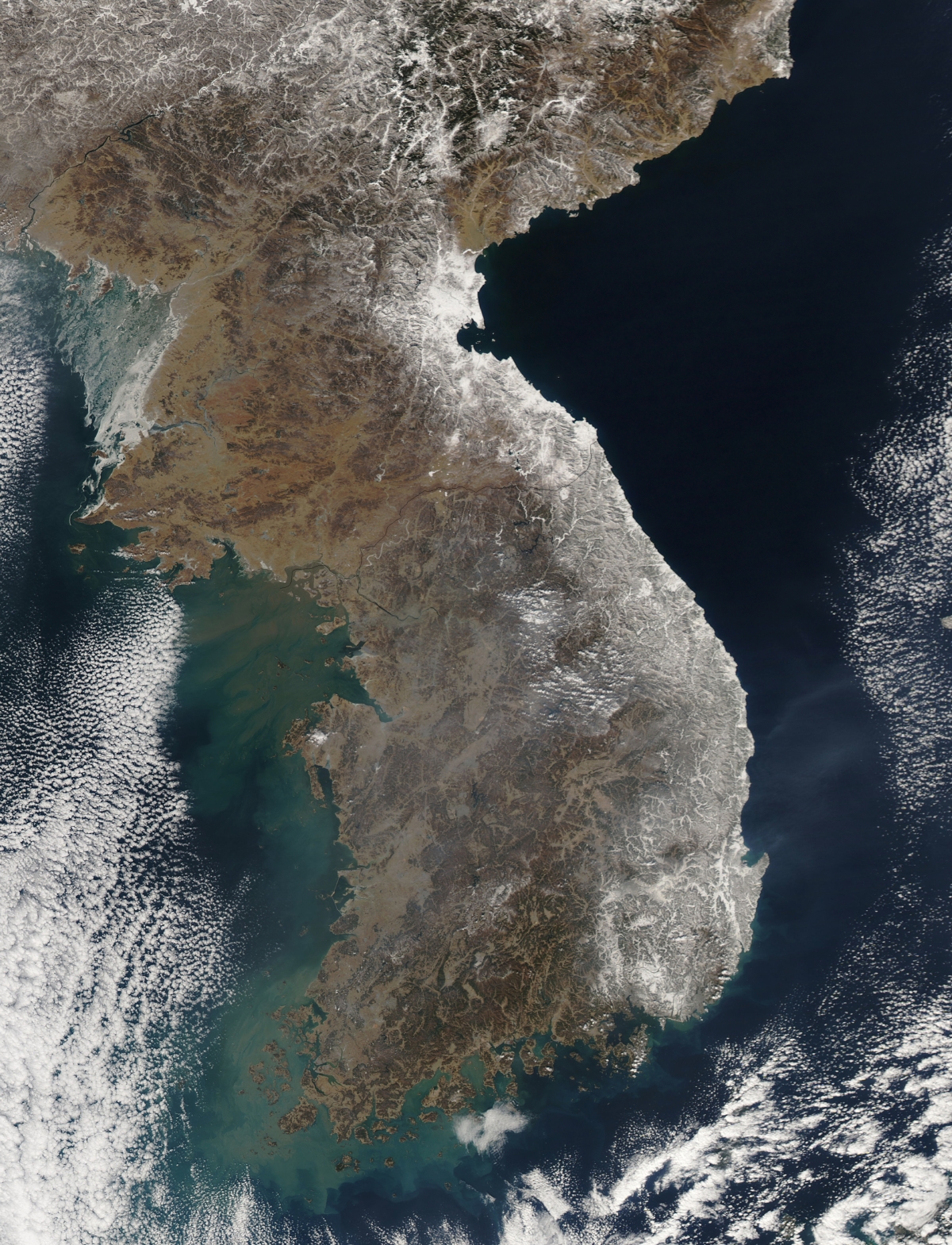 February 15, 2011 09/14/2009 Satellite view of snowfall along South Korea's east coast. East of Seoul, clusters of small white clouds cast shadows onto the surface below, but most of the white on the peninsula is snow.