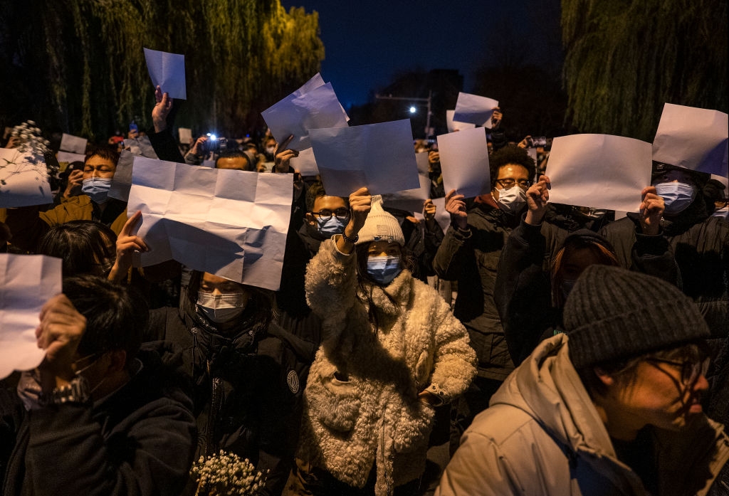 Protesters hold up a white piece of paper against censorship during a protest against Chinas strict zero COVID measures on November 27, 2022 in Beijing, China.