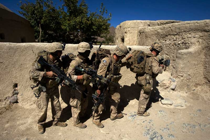 US Marines breach into a house in the Bhuji Bhast Pass in Farah Province, Afghanistan on October 9, 2009. The pass is a Taliban stronghold. (David Furst/AFP/Getty Images)
