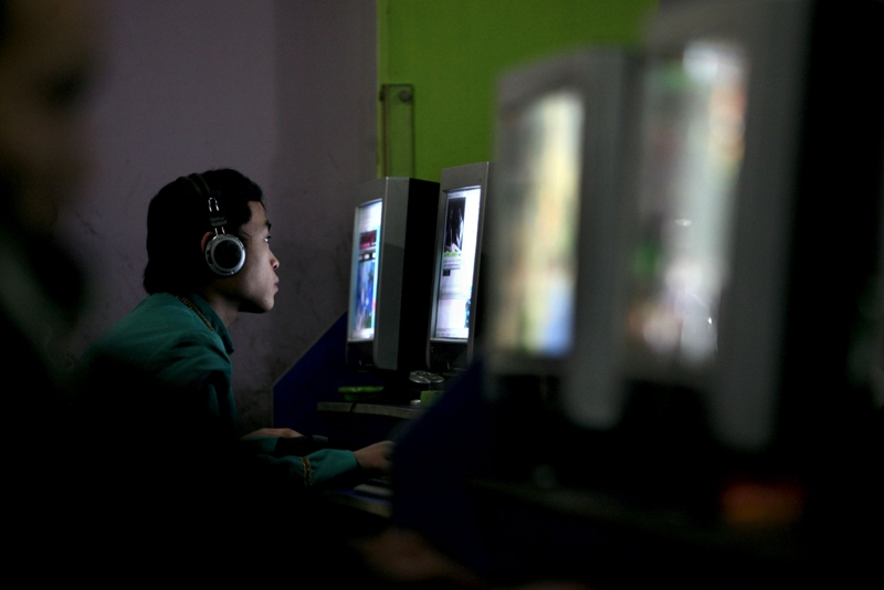 A Chinese youth uses a computer in an internet cafe in Chongqing, China. (China Photos/Getty Images)