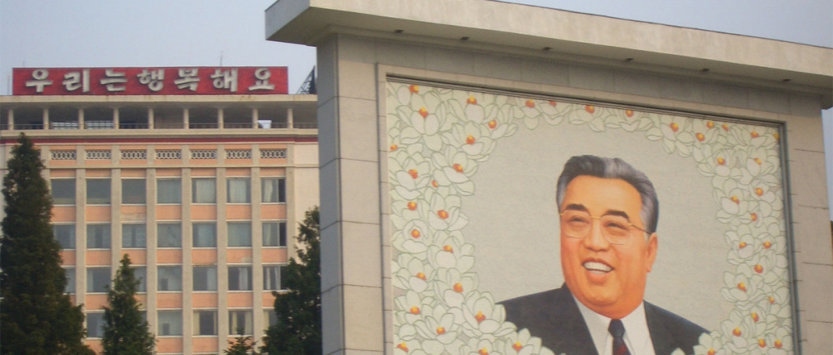 A mural of Kim Il Sung in the foreground (Anne Hilton)