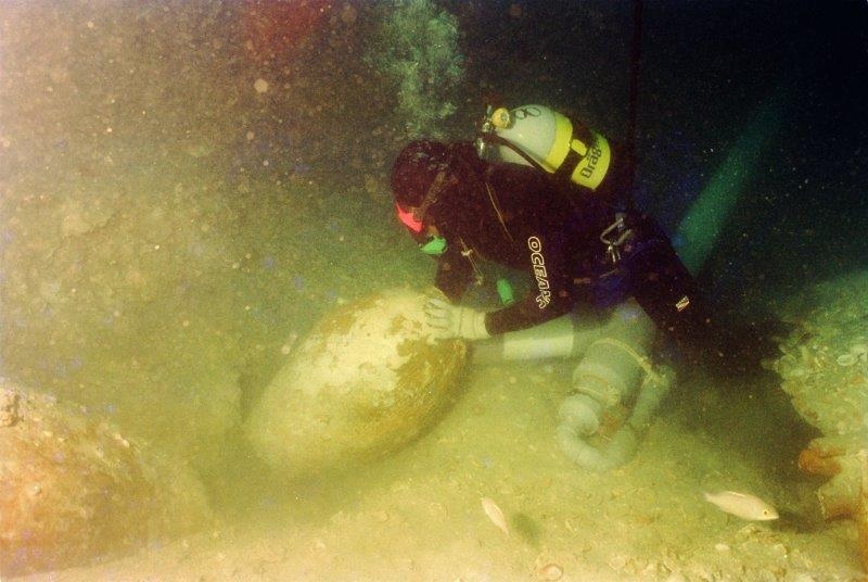 A diver for Seabed Explorations GBR with a storage jar from the wreck during the