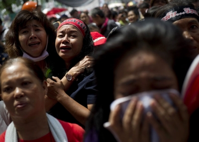 Thai "Red Shirt" anti-government protesters react as their leaders announce their surrender inside the protesters' camp in downtown Bangkok on May 19, 2010. Protest leaders told thousands of "Red Shirt" supporters to end their weeks-long rally after an army assault on their fortified encampment left at least five people dead. (Nicolas Asfouri/AFP/Getty Images)