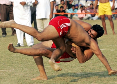 An Indian kabbadi player (L) is brought to the ground during the 2008 Sri Guru Gobind Singh Kabaddi Series in Gopalpur Majwind village, some 25 kms from Amritsar on November 9, 2008. (Narinder Nanu/AFP/Getty Images) 