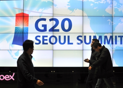 Visitors walk in front of a screen showing a sign for the upcoming G20 Summit at its venue in Seoul on November 4, 2010. (Jung Yeon-Je/AFP/Getty Images)