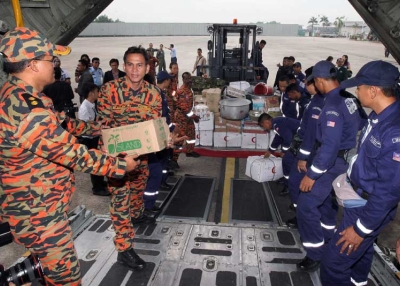 Members of the Special Malaysia Disaster Assitance and Rescue Team (SMART) load emergency and relief supplies into an aircraft for Japan at the Subang Airforce base in Kuala Lumpur on March 15, 2011. (AFP/Getty Images) 