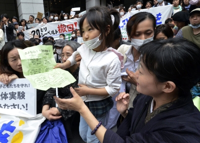 A girl holds her petition to ask the education ministry to protect children from radioactive contamination at Fukushima prefecture during a rally at the Education Ministry in Tokyo on May 23, 2011. (Yoshikazu Tsuno/AFP/Getty Images)
