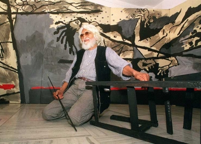 M.F. Husain (1915-2011) in March 1999, seated in front of his 40-foot (13-meter) canvas VIOLENCE at Gallery 7 in Mumbai, India. (Sebastian D'Souza/AFP/Getty Images) 
