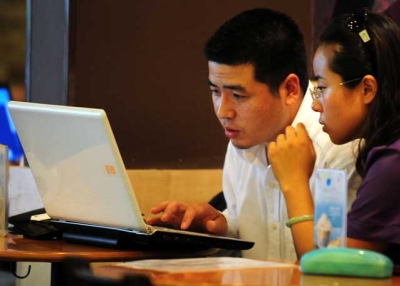 Chinese citizens on a laptop computer at a wireless cafe in Beijing in 2009. Richard H. Solomon argues that in many ways China's "totally wired" society has overtaken its political system. (Frederic J. Brown/AFP/Getty Images)