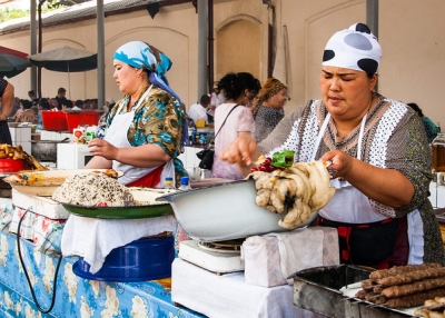 Two women hand-make traditional local cuisine in Tashkent, Uzbekistan on June 21, 2013. (Christopher Rose/Flickr)