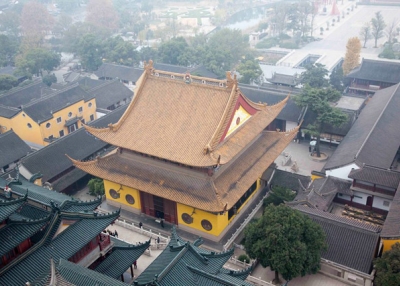 The yellow facade of a temple stands out from a view atop a building in Zhenjiang, China on December 6, 2013. (Tahiat Mahboob)