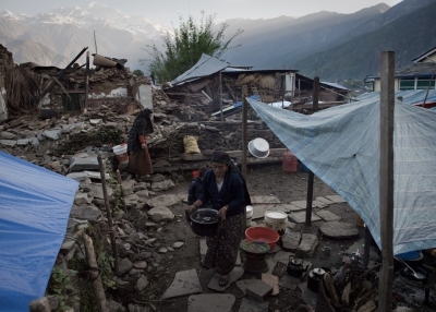 A resident holding a pot walks through tents set up near destroyed houses in the village of Barpak in north central Nepal, nine days after a 7.8 magnitude earthquake struck the Himalayan nation on April 25. (Nicolas Asfouri/Getty Images)