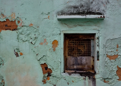 A rusty window set in a peeling wall in Macau on January 4, 2016. (roaming-the-planet/Flickr)