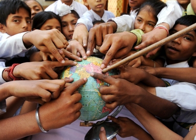 Students point to India on a globe.