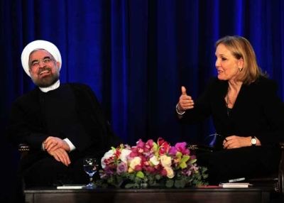 Iranian President Hassan Rouhani smiles while answering questions from Asia Society President Josette Sheeran at an Asia Society event on the sidelines of the 68th UN General Assembly in New York on Sept. 26, 2013. (Emmanuel Dunand/Getty Images)