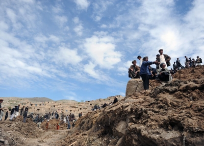 Afghan villagers search through dirt and debris at the scene in the landslide-hit Aab Bareek village in Argo district of Badakhshan on May 5, 2014. At least 300 were killed, and officials warned the death toll could rise by hundreds more. (Farshad Usyan/AFP/Getty Images)