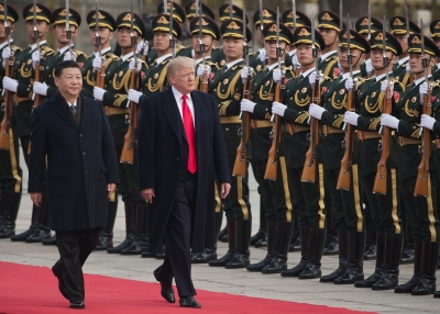 China's President Xi Jinping and U.S. President Donald Trump review Chinese honour guards during a welcome ceremony at the Great Hall of the People