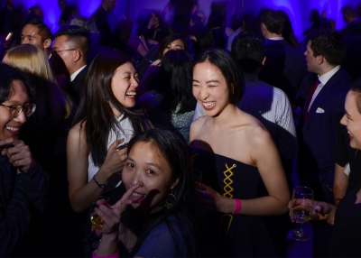 Guests share a laugh at an Asia Society party