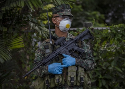 A Filipino policeman wearing a facemask and gloves as coronavirus spreads