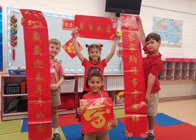 First-graders holding the Chinese Spring couplet on the Lunar New Year day