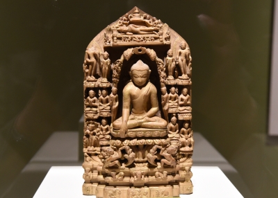 Carved sculpture of the sitting Buddha surrounded by smaller figures