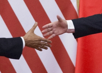 U.S. President Barack Obama (L) and China's President Xi Jinping reach out to shake hands following a bilateral meeting at the Great Hall of the People in Beijing on November 12, 2014. (Mandel Ngan/AFP/Getty Images)