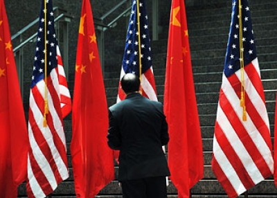 A US official adjusts Chinese and US flags in Washington, DC on July 27, 2009. (Jewel Samad/AFP/Getty Images)