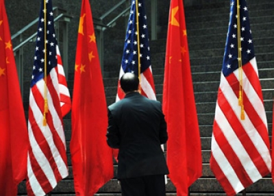 A US official adjusts Chinese and US flags at the Ronald Reagan Building and International Trade Center in Washington, DC, on July 27, 2009.