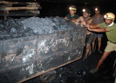 Indian coal miners push a trolley laden with coal inside an underground tunnel of a mine at Godavarikhani, July 27, 2007. (NOAH SEELAM/AFP/Getty Images) 