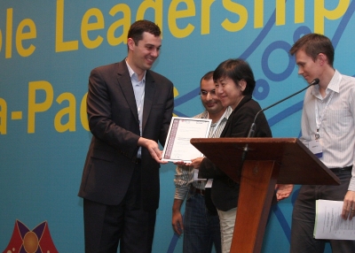 HOME President Bridget Tan receives her award from Asia 21 Fellows John Ciorciari, Soofian Zuberi, and Gregory Fox