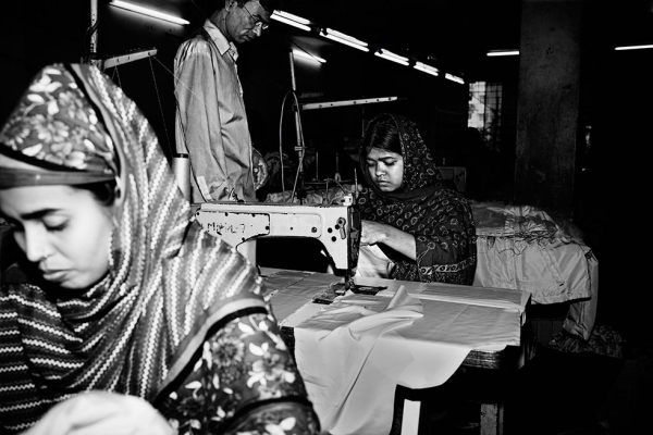 Shahana, 22 (L), and Hasina, 18 (R), both operators in the sewing section at Luman Group Garments Factory, in Rampura, Dhaka, Bangladesh. (Gazi Nafis Ahmed)