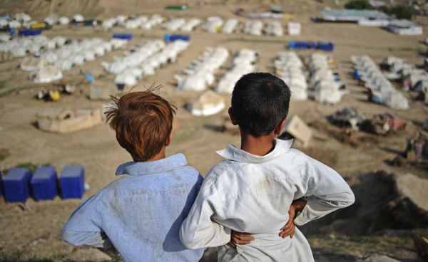 Two boys look out over a large relief camp on September 23, 2010.