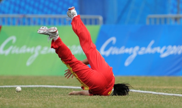 Yu Miao of China stops the ball from reaching the boundary during the women's group pool