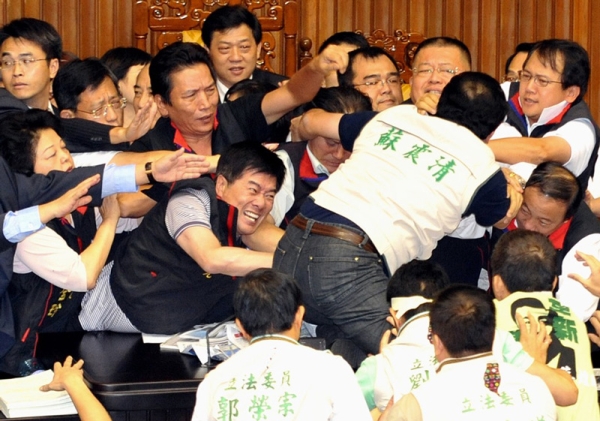 Lawmakers used books, garbage bins, tea cups, and themselves to attack one another. (Patrick Lin/AFP/Getty Images)