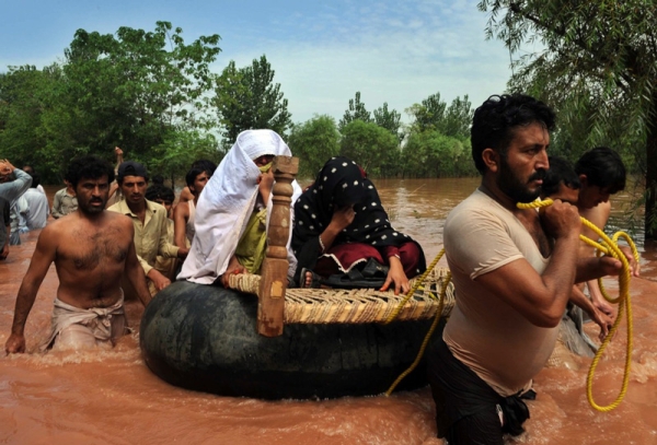 Residents of a flood-hit area of Nowshera evacuate to safety on July 30, 2010. A center of Pakistan&apos;s textile industry, Nowshera is traditionally famous for its spinning mills. (A. Majeed/AFP/Getty Images)
