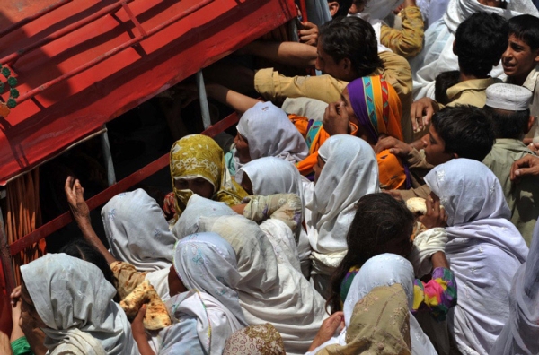 Survivors gather to receive food in Nowshera on August 1, 2010.  (A. Majeed/AFP/Getty Images)
