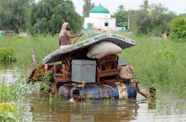 Villagers shift their household items through a flooded area of Pathan Wala on August 16, 2010. Pakistan&apos;s devastating floods are now threatening ancient archeological sites, on top of leaving millions of people dependent on humanitarian aid to survive, an antiquities official said. (Banaras Khan/AFP/Getty Images)
