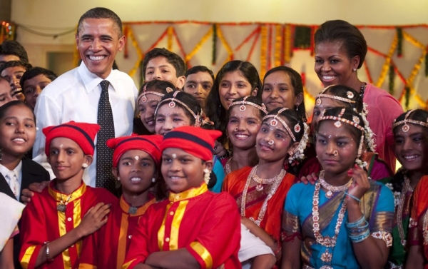 US President Barack Obama (L) and First Lady Michelle Obama (R) posed with children at a cultural event at The Holy Name High School in Mumbai, India on Nov. 7.Coming at a time of reduced American clout, Obama&apos;s 10-day Asian trip focused on opportunities for American business. (Jim Watson/AFP/Getty Images)