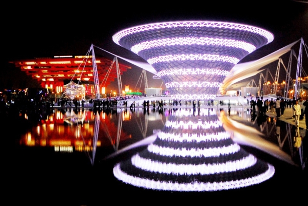 Visitors walked past the illuminated Chinese pavilion (L) and the trumpet-shaped &quot;sun valley&quot; (R) at the World Expo 2010 in Shanghai on May 2. Held from May 1 to October 31, the 2010 Expo was the largest and most expensive in the history of Worlds Fairs, attracting a record 73 million visitors. (STR/AFP/Getty Images)