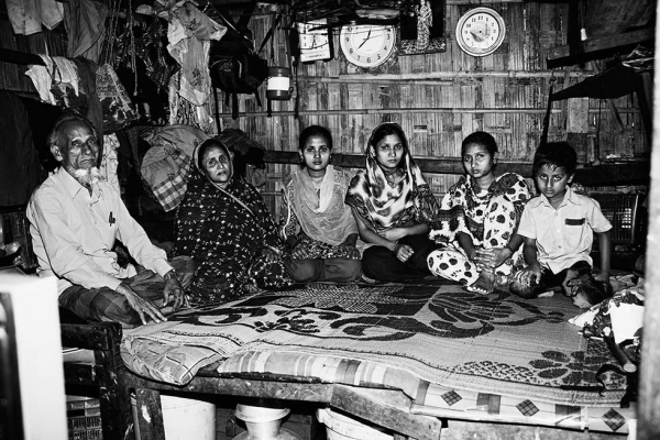A family of six, who had been living in the same bamboo structure for 21 years, in Chittagong, Bangladesh. The mother and three sisters are all employed at Ready Made Garments' factories. (Gazi Nafis Ahmed)