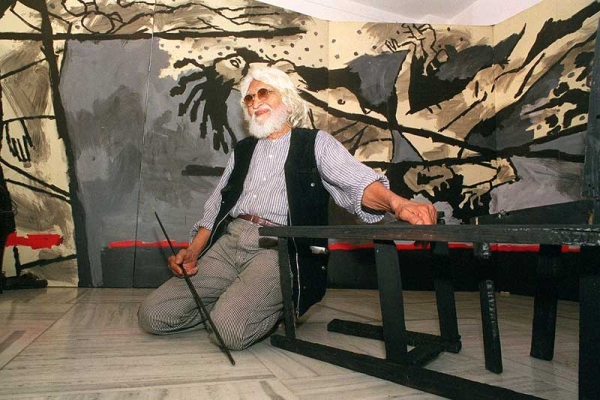 M.F. Husain (1915-2011) in March 1999, seated in front of his 40-foot (13-meter) canvas VIOLENCE at Gallery 7 in Mumbai, India. (Sebastian D'Souza/AFP/Getty Images) 